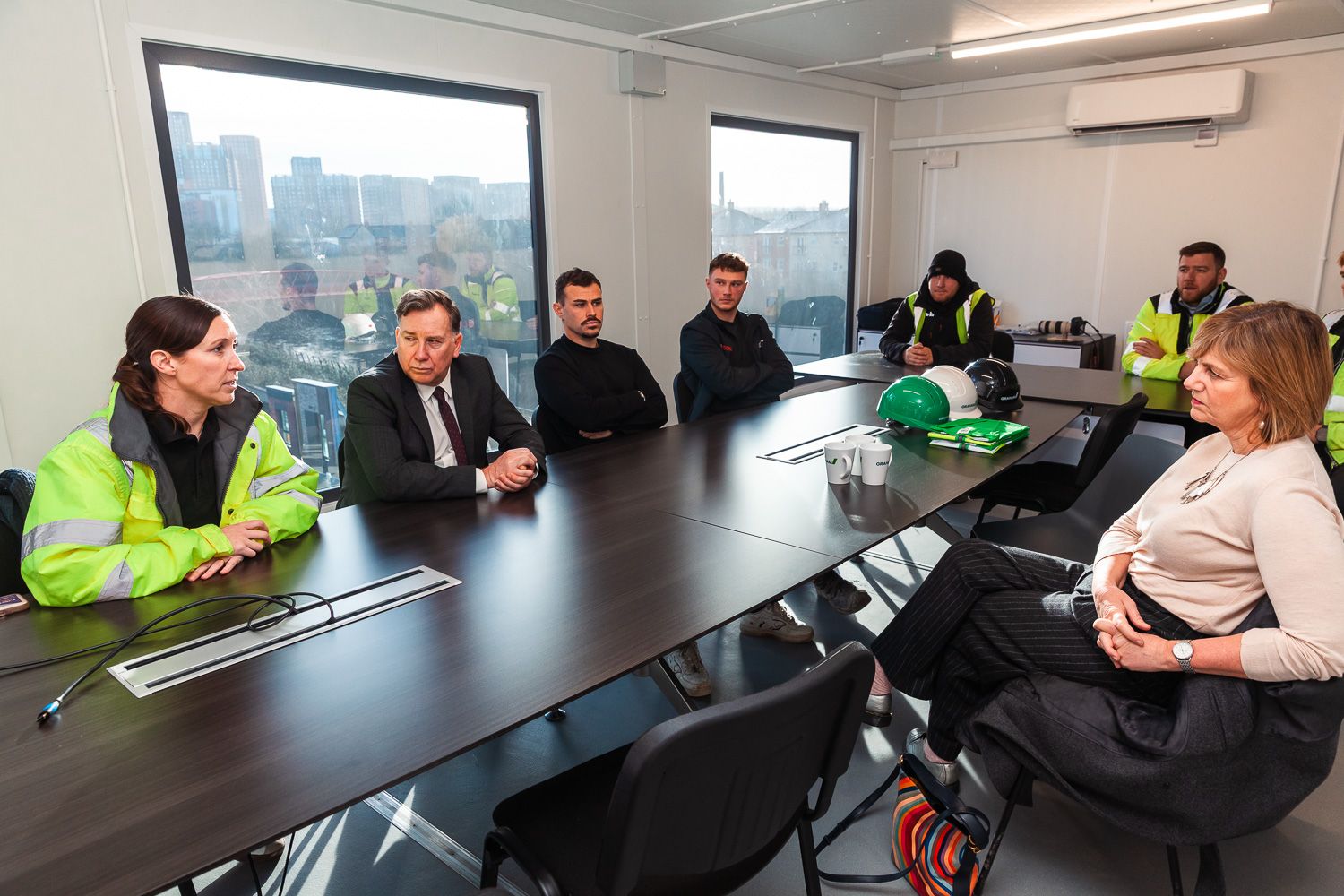 Photograph of local transport minister speaking with staff on visit to GRAHAM Dyecoats Leeds site