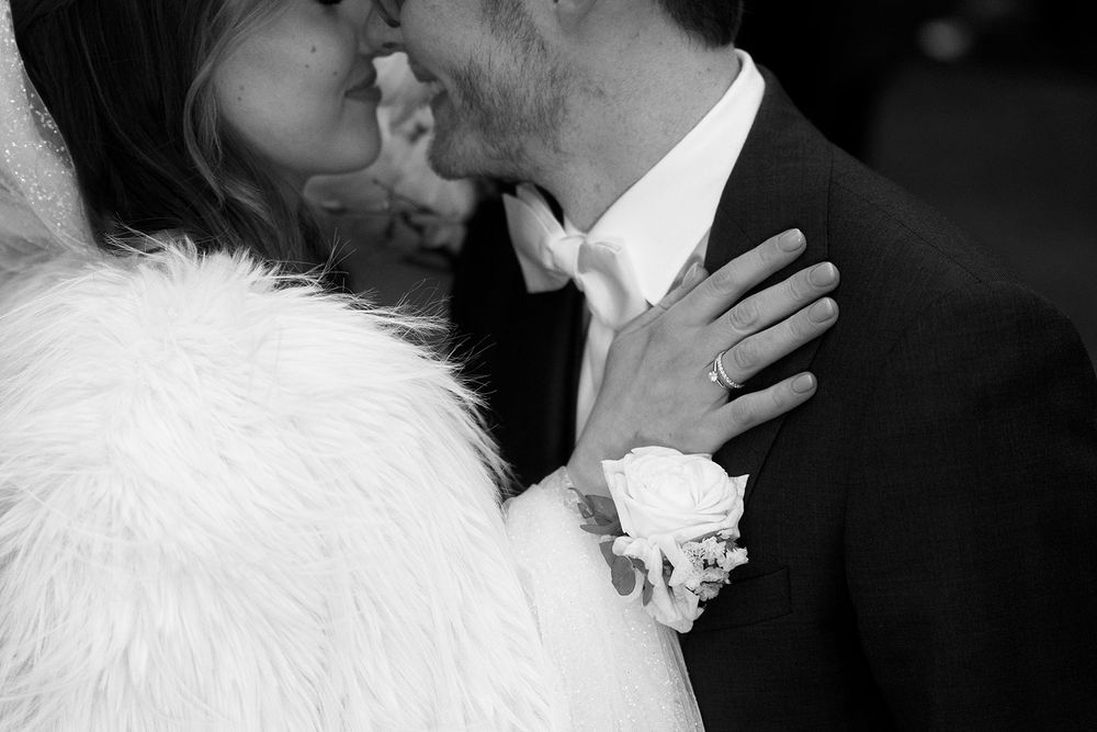 A romantic black and white wedding photo series showing intimate moments between newlyweds.