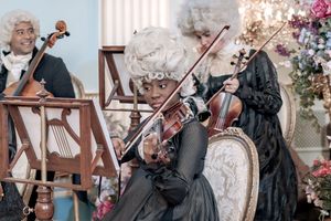Behind the scenes of a Bridgerton Netflix filming setup at Newark Town Hall, showing a violinist playing the Bridgeton theme tune.