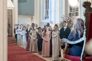 Behind the scenes of a Bridgerton Netflix filming setup at Newark Town Hall, showing cast applauding lady Sarah.