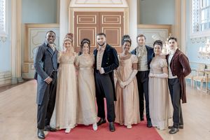 Behind the scenes of a Bridgerton Netflix filming setup at Newark Town Hall, showing some of the cast dancers in their ballroom attire.