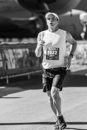 Black and white sequence showing a runner's legs and feet in motion during a race competition.