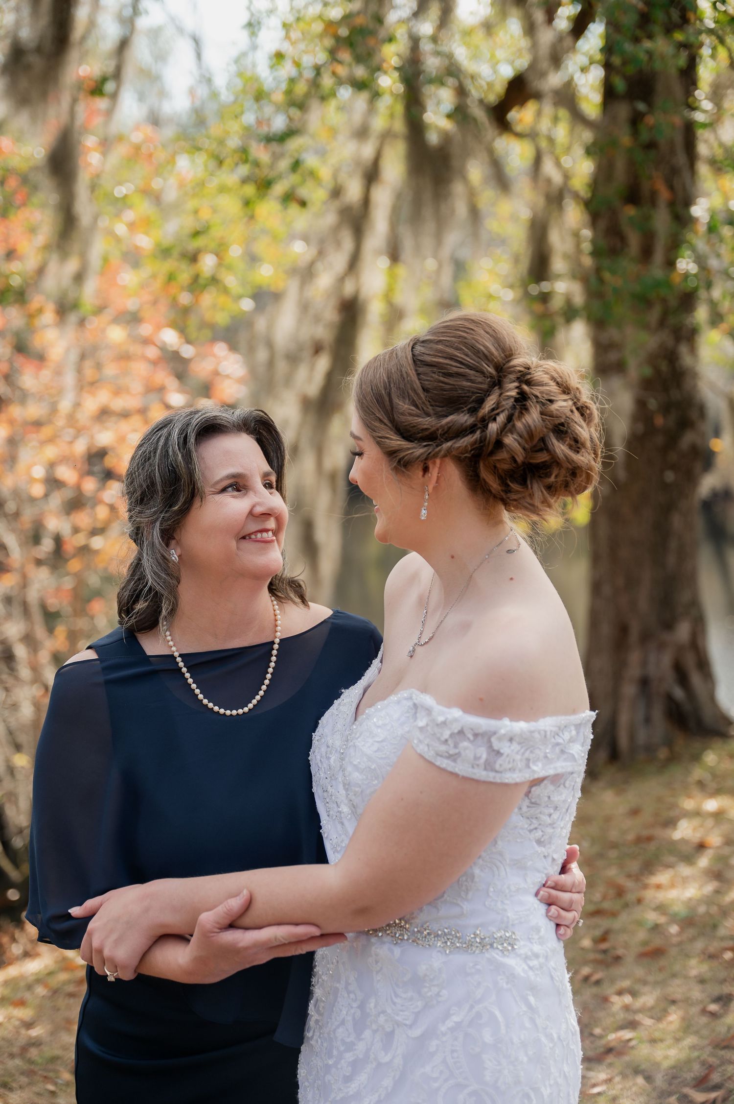 Joyful wedding moment shared between two people against an autumn backdrop.