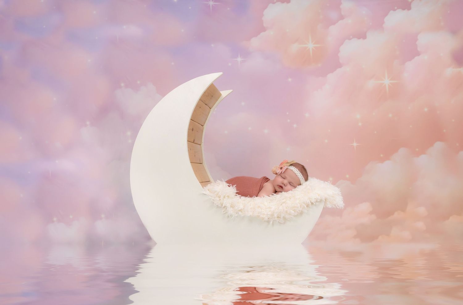 Dreamy pastel pink clouds with a crescent moon silhouette creating a peaceful celestial backdrop.