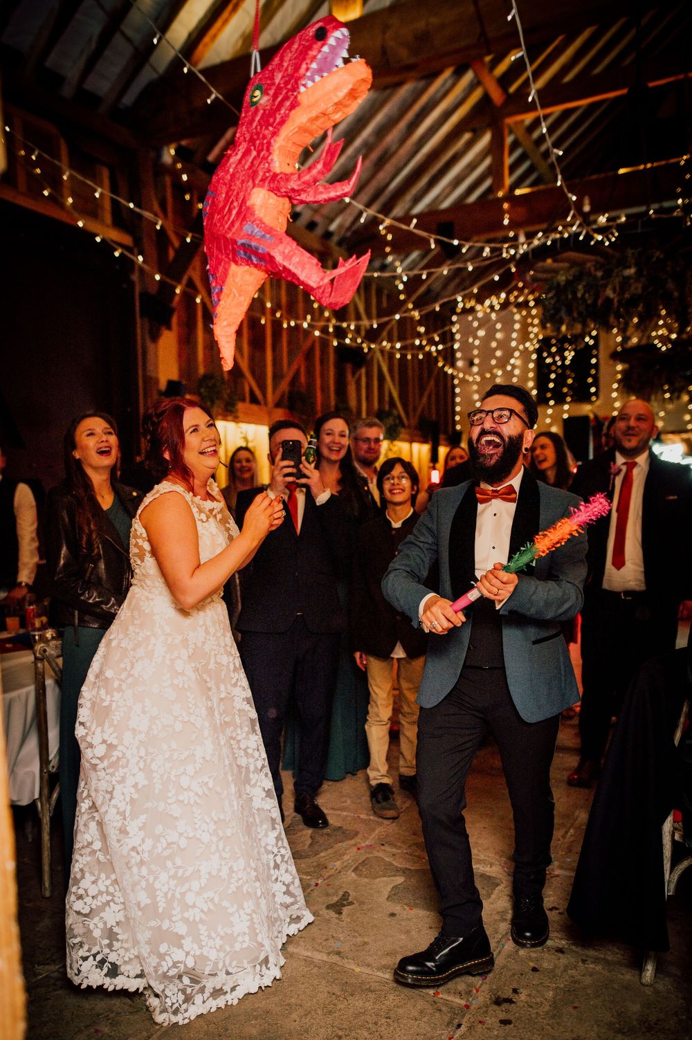 Wedding reception dance party scene with string lights overhead and guests celebrating on the dance floor. Worcestershire Wedding photograph