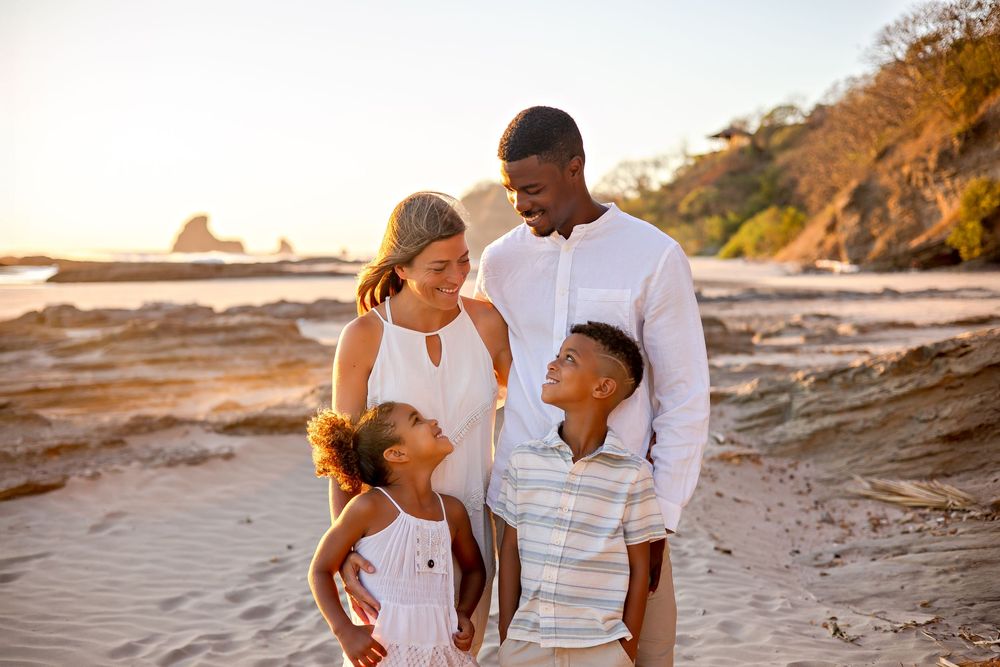 A couple walks together along a scenic beach at sunset sharing intimate moments in multiple candid photos.