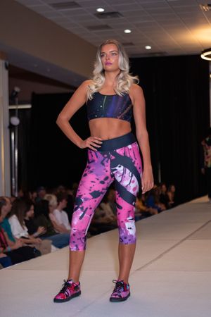 Athletic wear featuring pink and purple tie-dye capri leggings displayed on fashion catwalk.