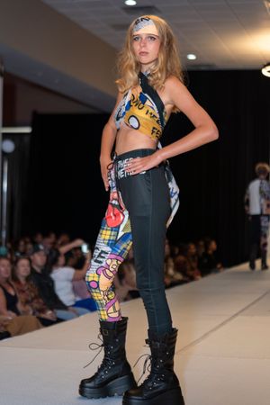 Edgy fashion look featuring dark pants with colorful graphic print detail and combat boots.