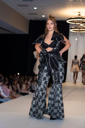 Floral print black and white maxi dress displayed on fashion runway.