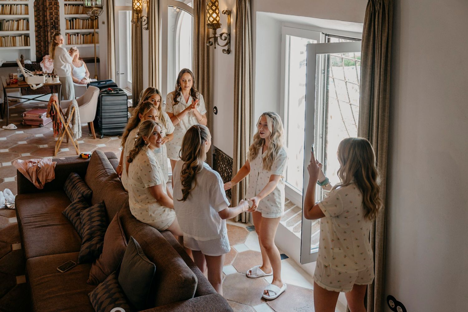 Wedding party preparations in an elegant indoor setting with natural light.