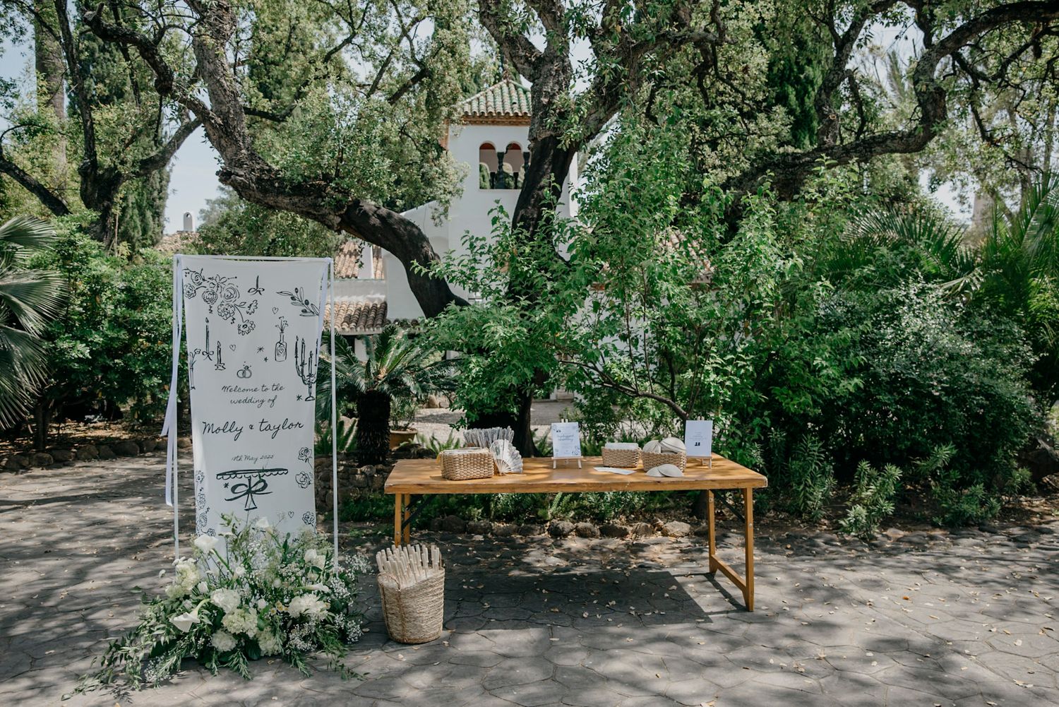 Garden wedding venue entrance with lush greenery and stone pathways.