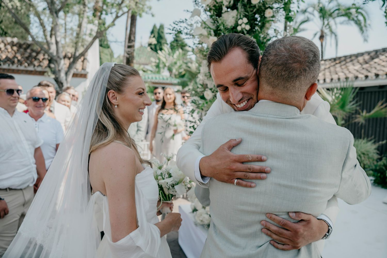 Intimate moments captured during an outdoor wedding ceremony under natural greenery.
