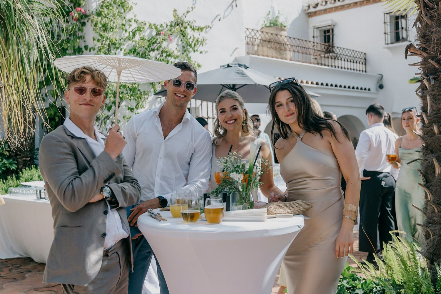 Wedding guests mingle and socialize during an outdoor reception at a Spanish villa.