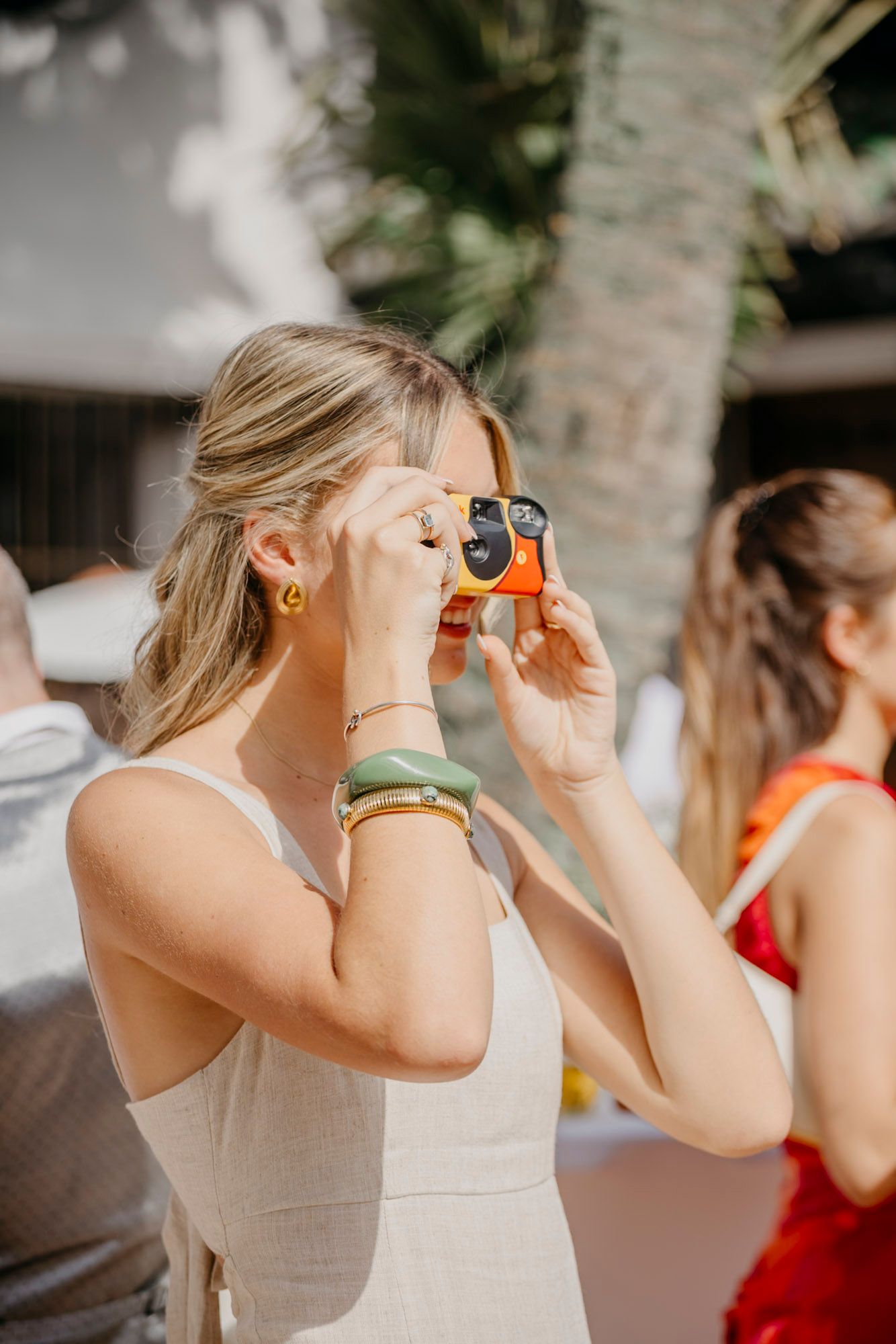 Wedding party members using binoculars during an outdoor celebration.