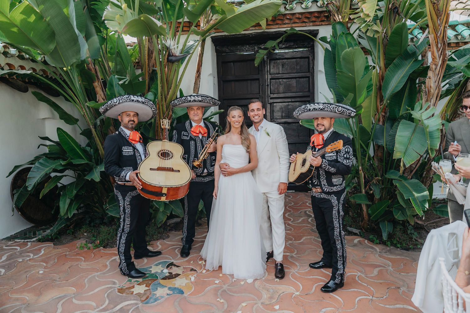 Tropical garden wedding ceremony setup with palm trees and lush greenery.