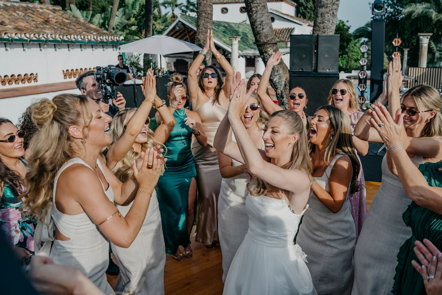 Wedding celebration with guests dancing and having fun on the dance floor.