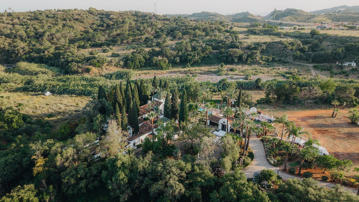 Panoramic landscape view of rolling hills and countryside in Mediterranean setting.