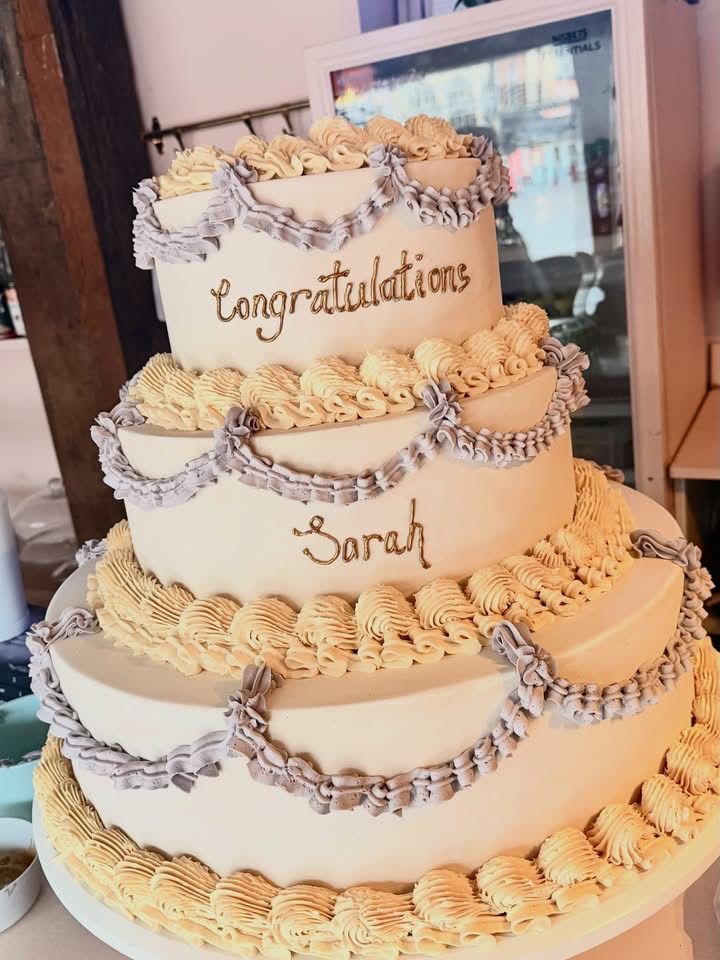 Bridgerton at Newark Town Hall in Nottinghamshire, photographed behind the scenes for the Netflix production. Crumbly bun 3 tier cake.