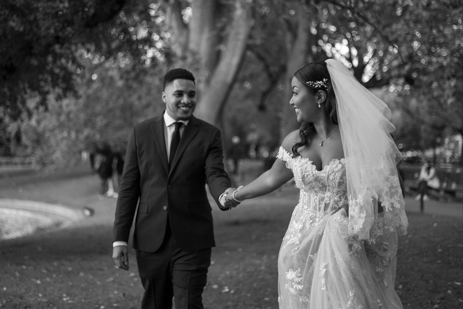 A collection of black and white wedding photos showing couples in formal attire outdoors in a garden setting.