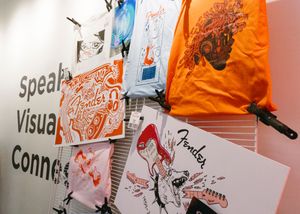 Fender related merchandise, artwork, t-shirts, etc. displayed on a wall