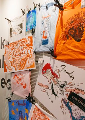Fender related merchandise, artwork, t-shirts, etc. displayed on a wall