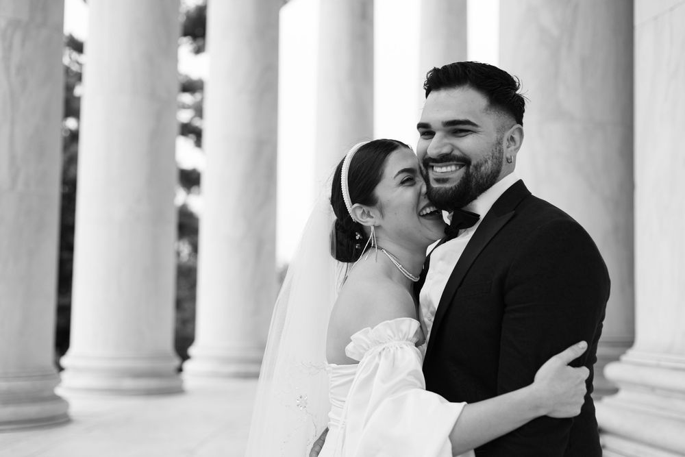 Bride and groom share romantic moments in black and white photos against elegant white columns.