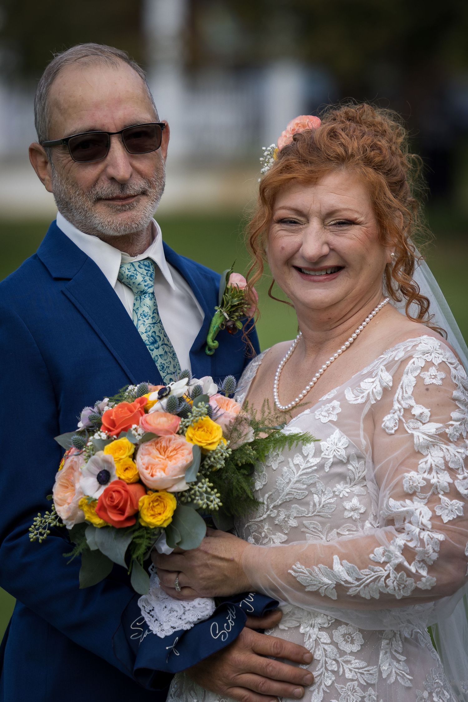 frederick maryland wedding photographer A joyful wedding portrait showcasing a beautiful lace dress and colorful bouquet.