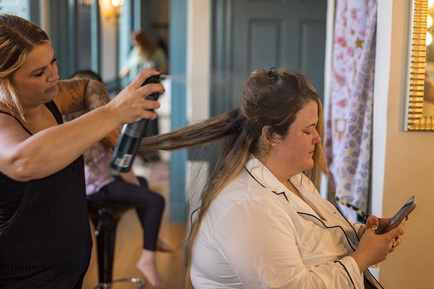 frederick maryland wedding photographer Hair stylist working on wedding day preparation with styling tools.