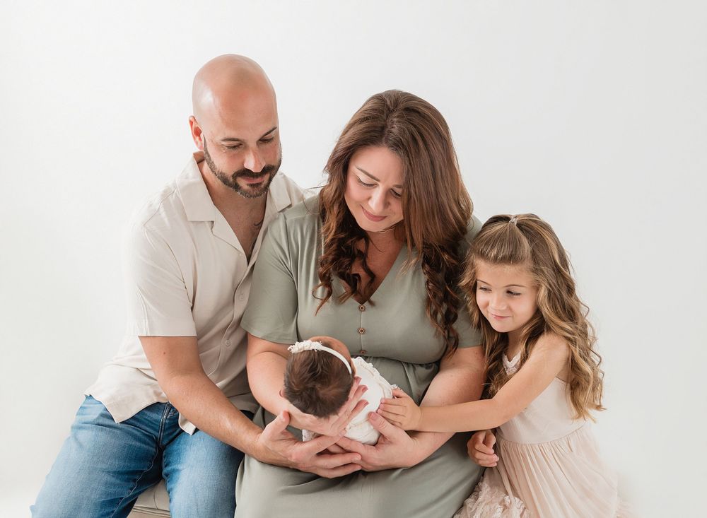 Family photo session showing loving interactions on white background.
