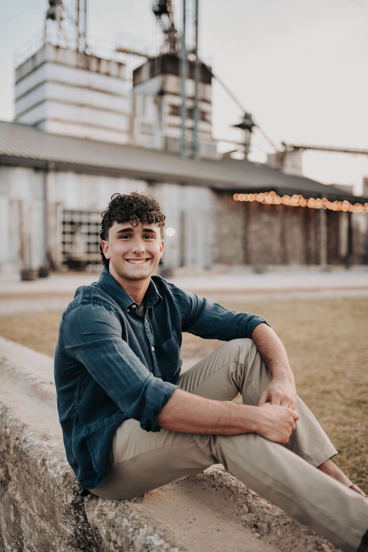 Urban senior photo session near TUPPS Brewery with industrial textures and sunset lighting
