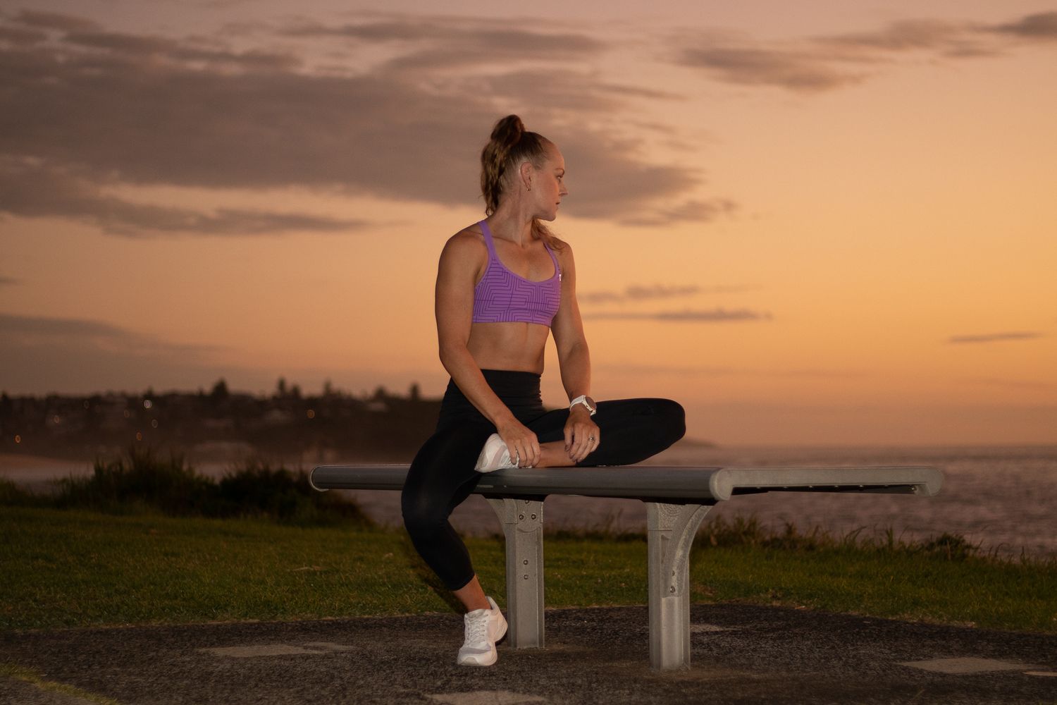 Jemma Aitken relaxing before dawn during a fitness photoshoot at Freshwater Beach — commercial portrait photography