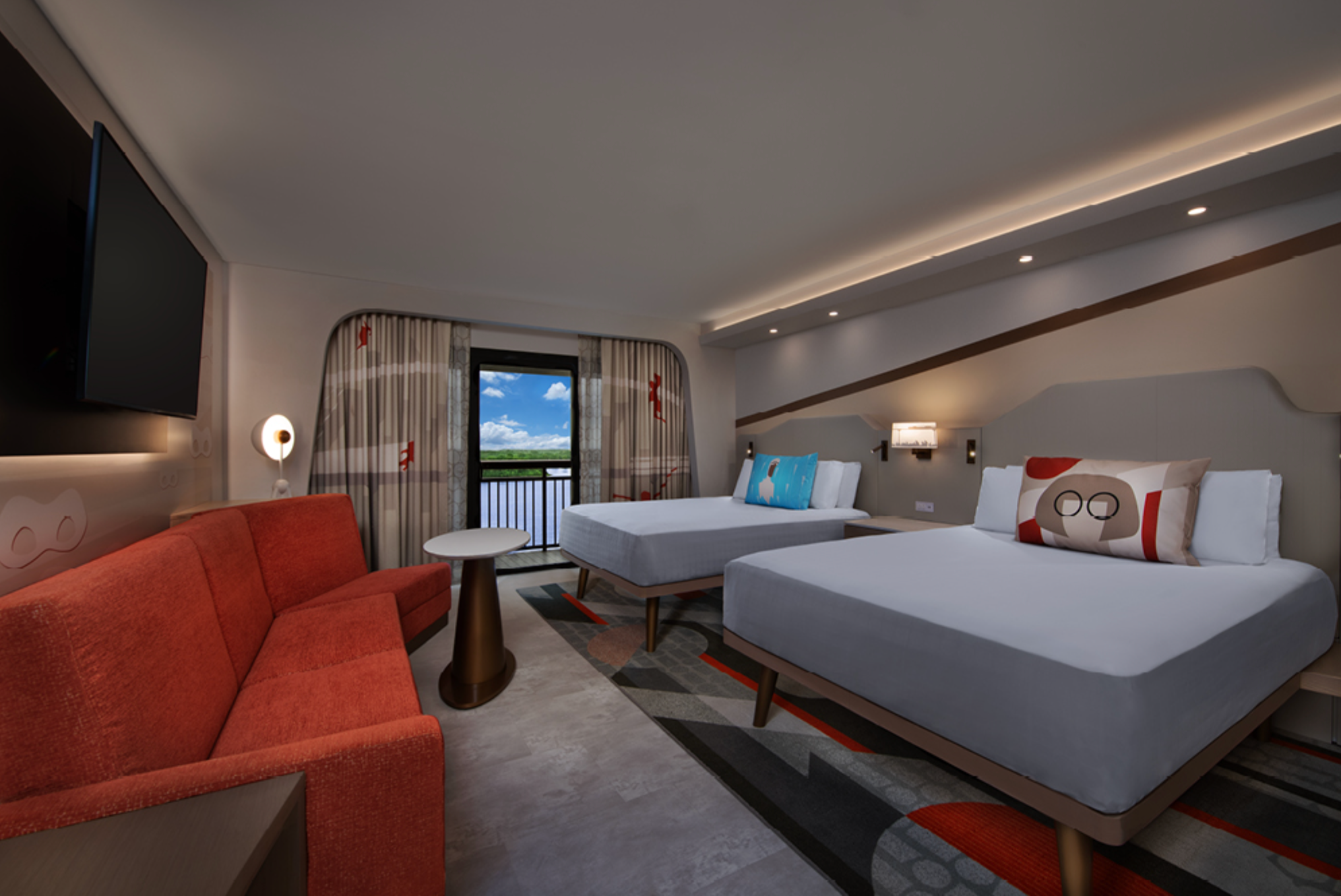 Modern hotel room interior with two beds, red sofa, and balcony view.