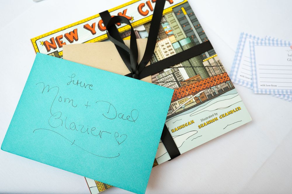 Handwritten gift book addressed to Mom and Dad with New York City postcards.