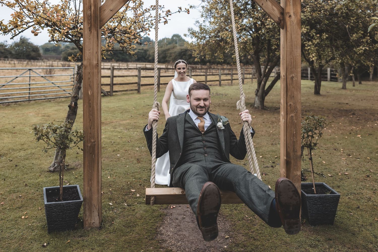 A fun genuine moment on a swing between bride and groom.