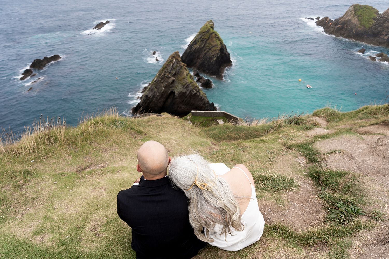 A series of photos showing seabirds soaring over dramatic coastal cliffs with turquoise waters below.