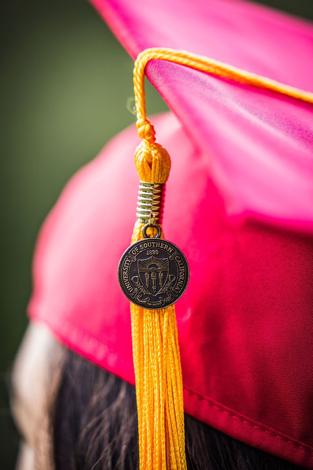 Close-up of a USC graduation cap tassel with gold fringe and University of Southern California medallion charm.