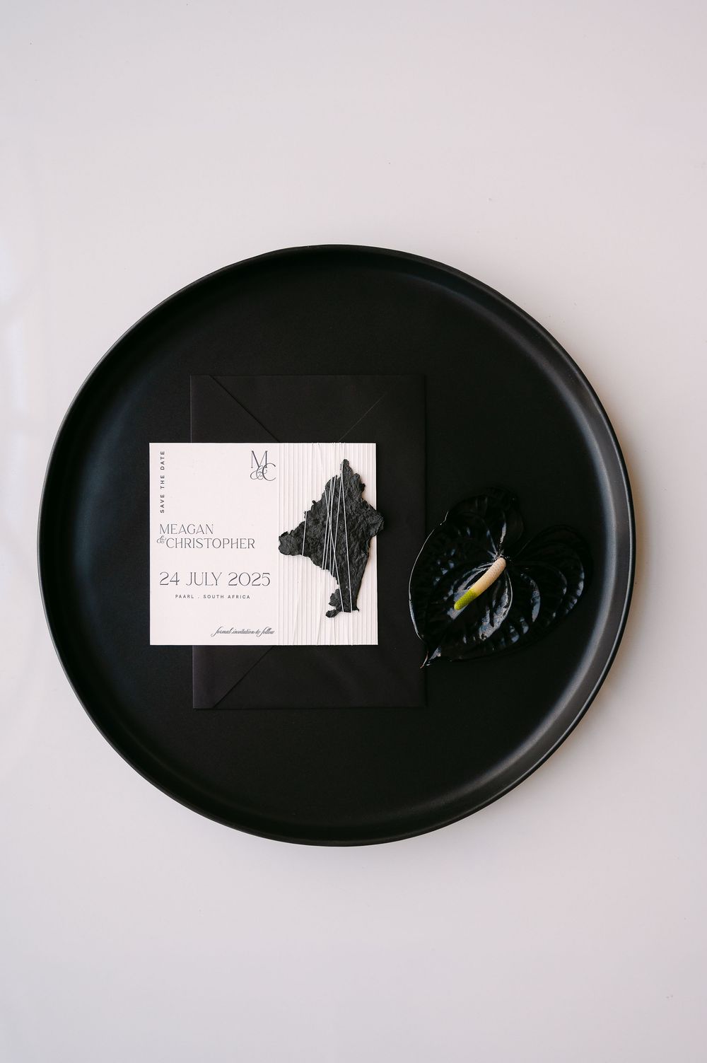 Four views of a minimalist black oval serving platter with white paper tags creating an elegant presentation.