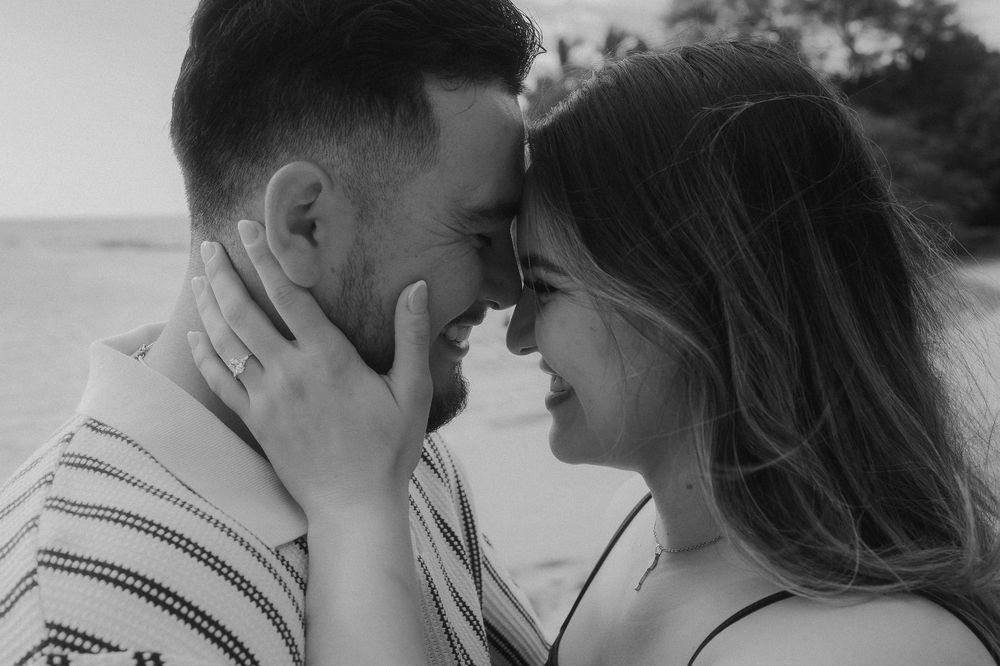 Black and white sequence showing tender emotional moments between a couple after a beach proposal.