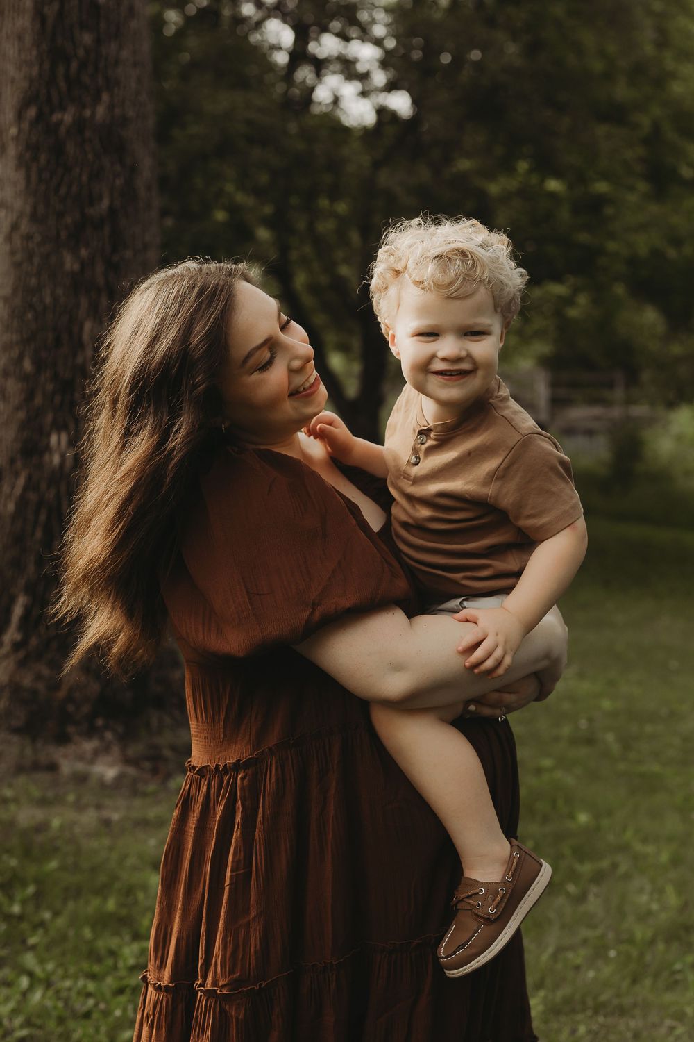 A heartwarming sequence of photos showing a parent and child playing and embracing in a park setting at sunset.
