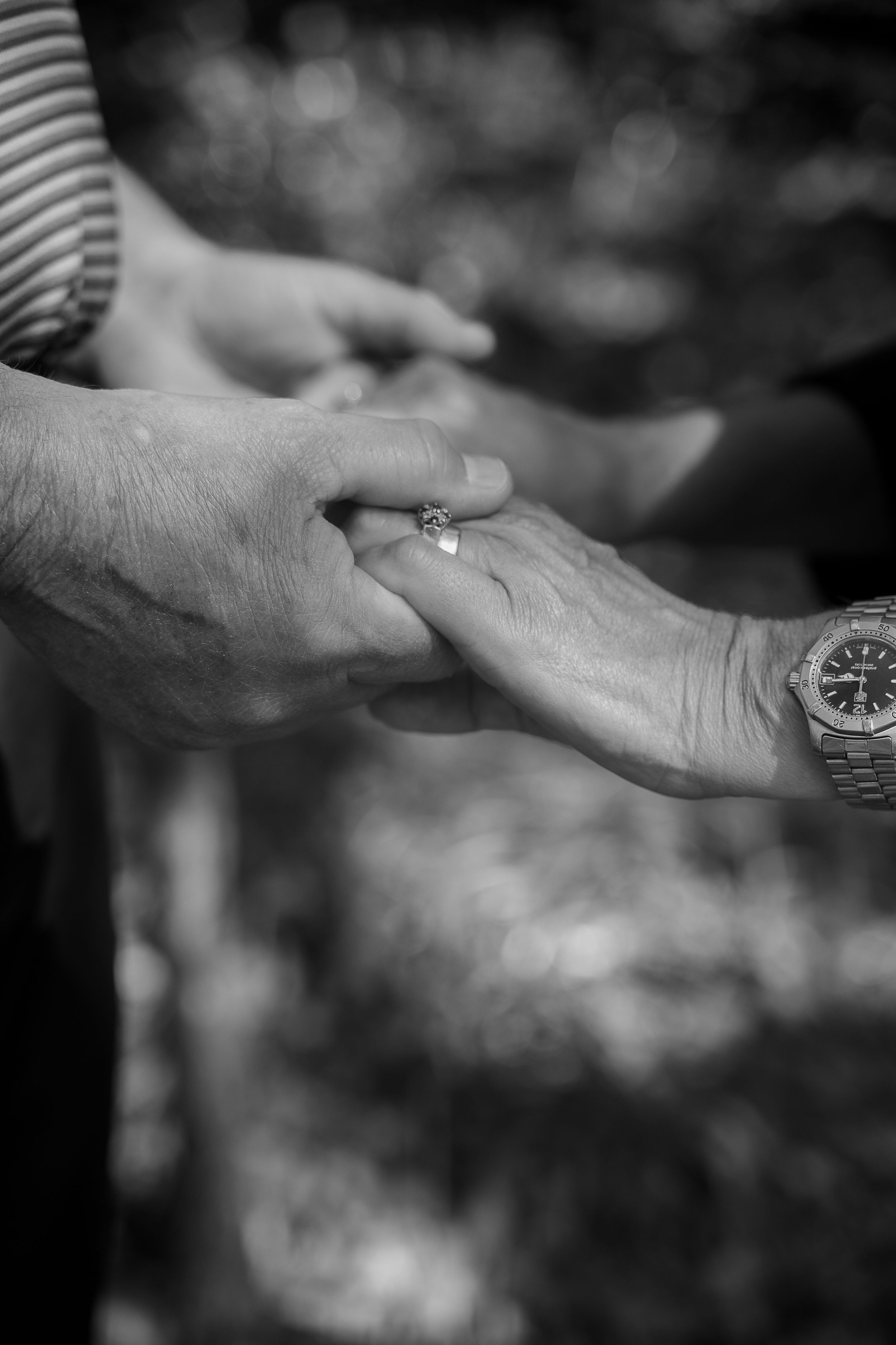 A series of black and white close-up shots showing hands exchanging an engagement ring in a romantic proposal sequence.