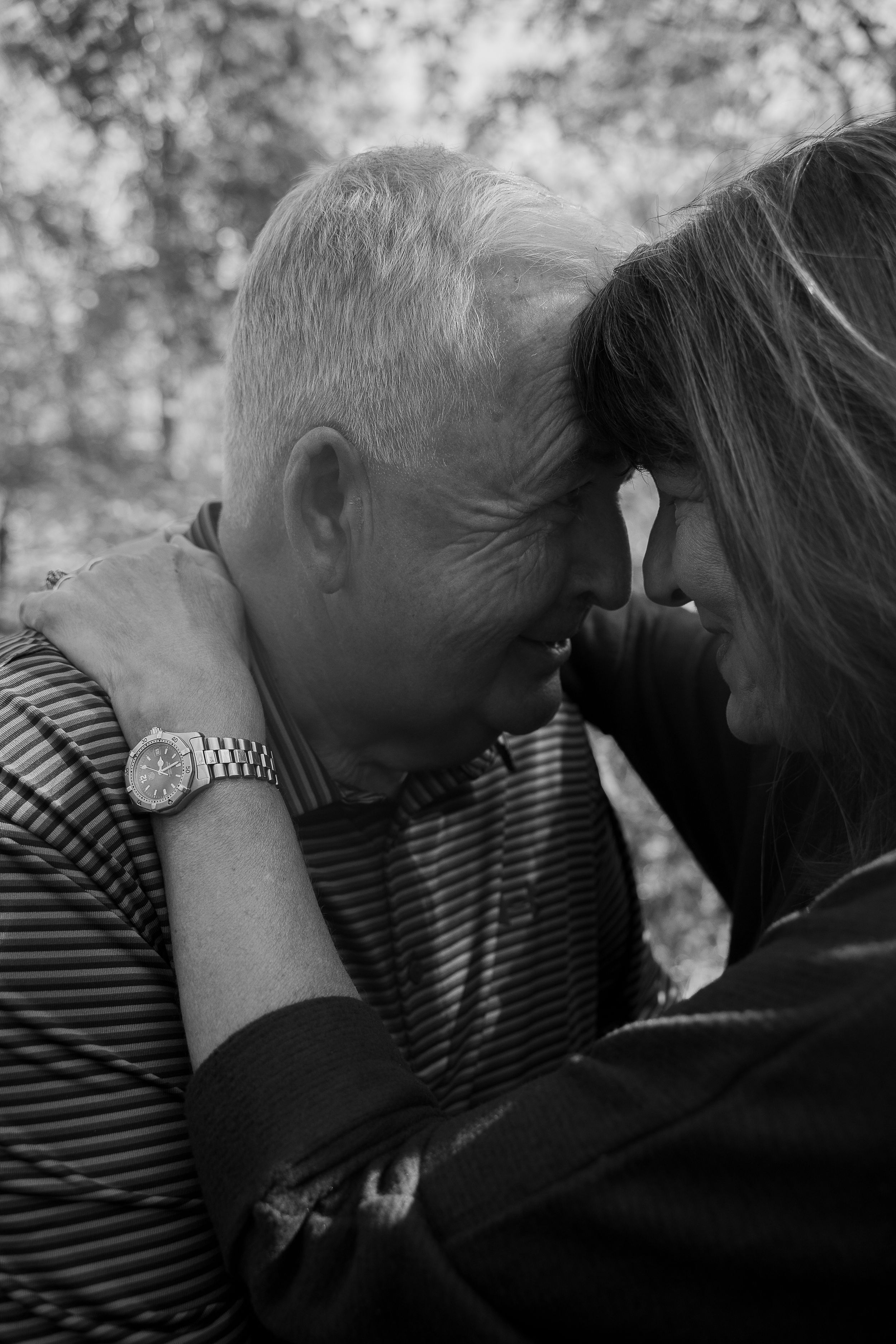 A romantic black and white photo series showing an intimate couple kissing in silhouette against a blurred background.