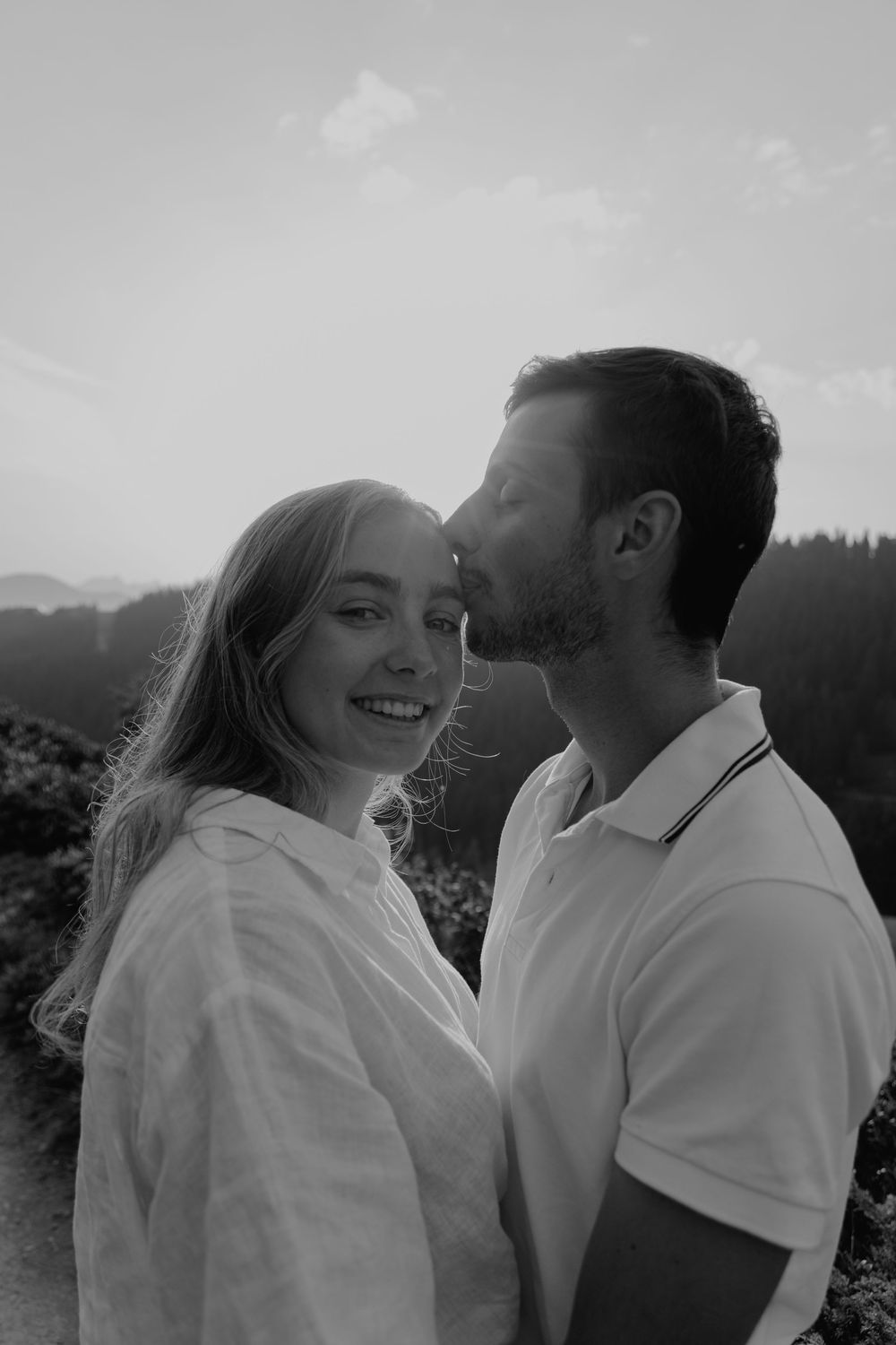 Black and white photo series capturing intimate moments with mountain scenery.