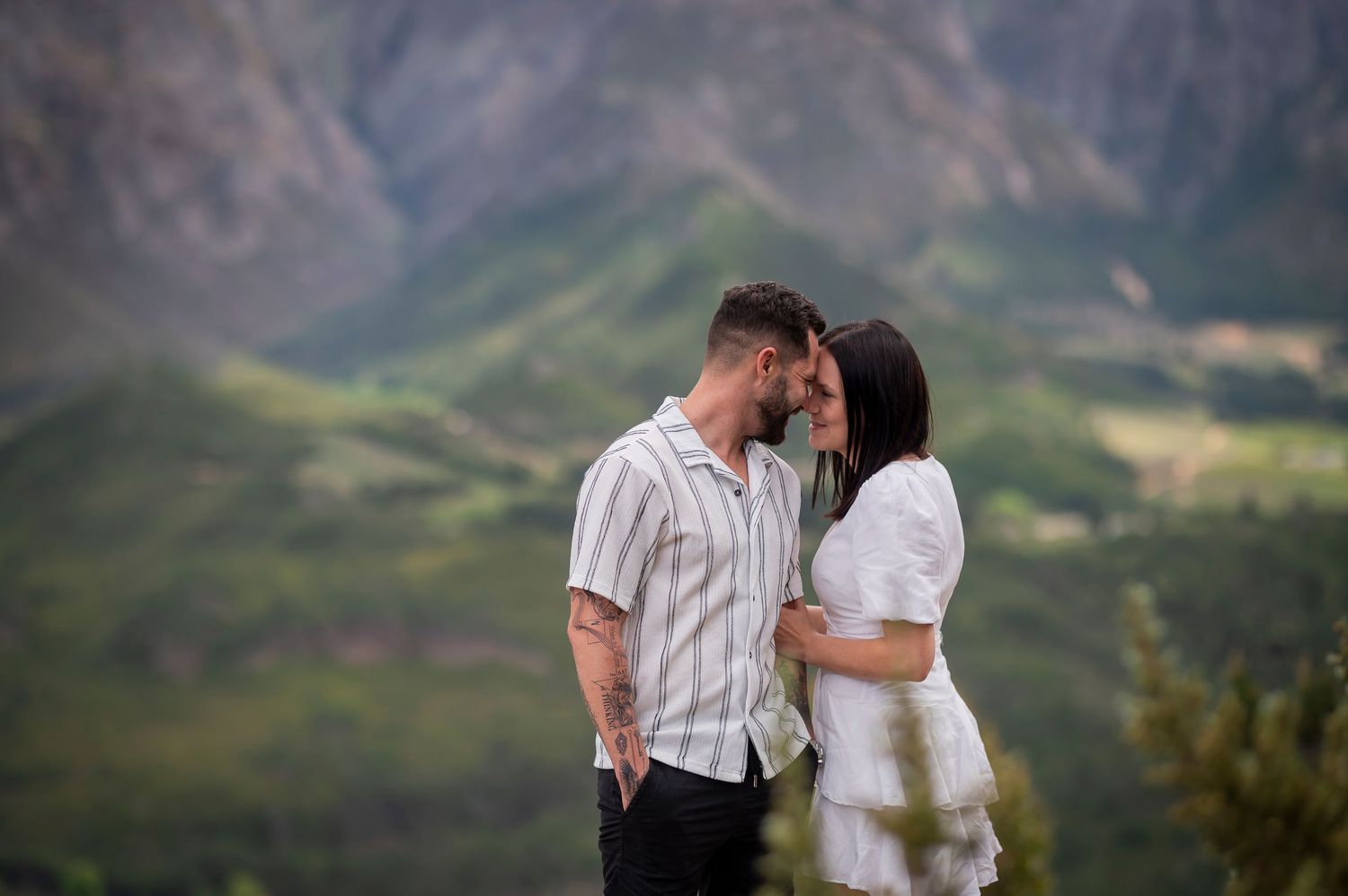A series of intimate couple portraits captured in a scenic mountain landscape during golden hour.