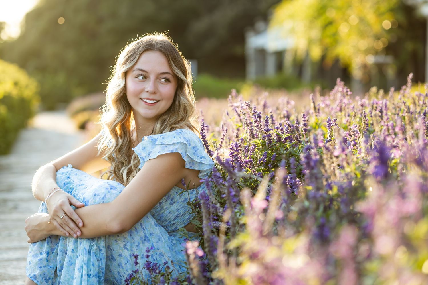 A light blue summer dress contrasts beautifully with a purple lavender field at golden hour sunset. High school senior photographer RVA