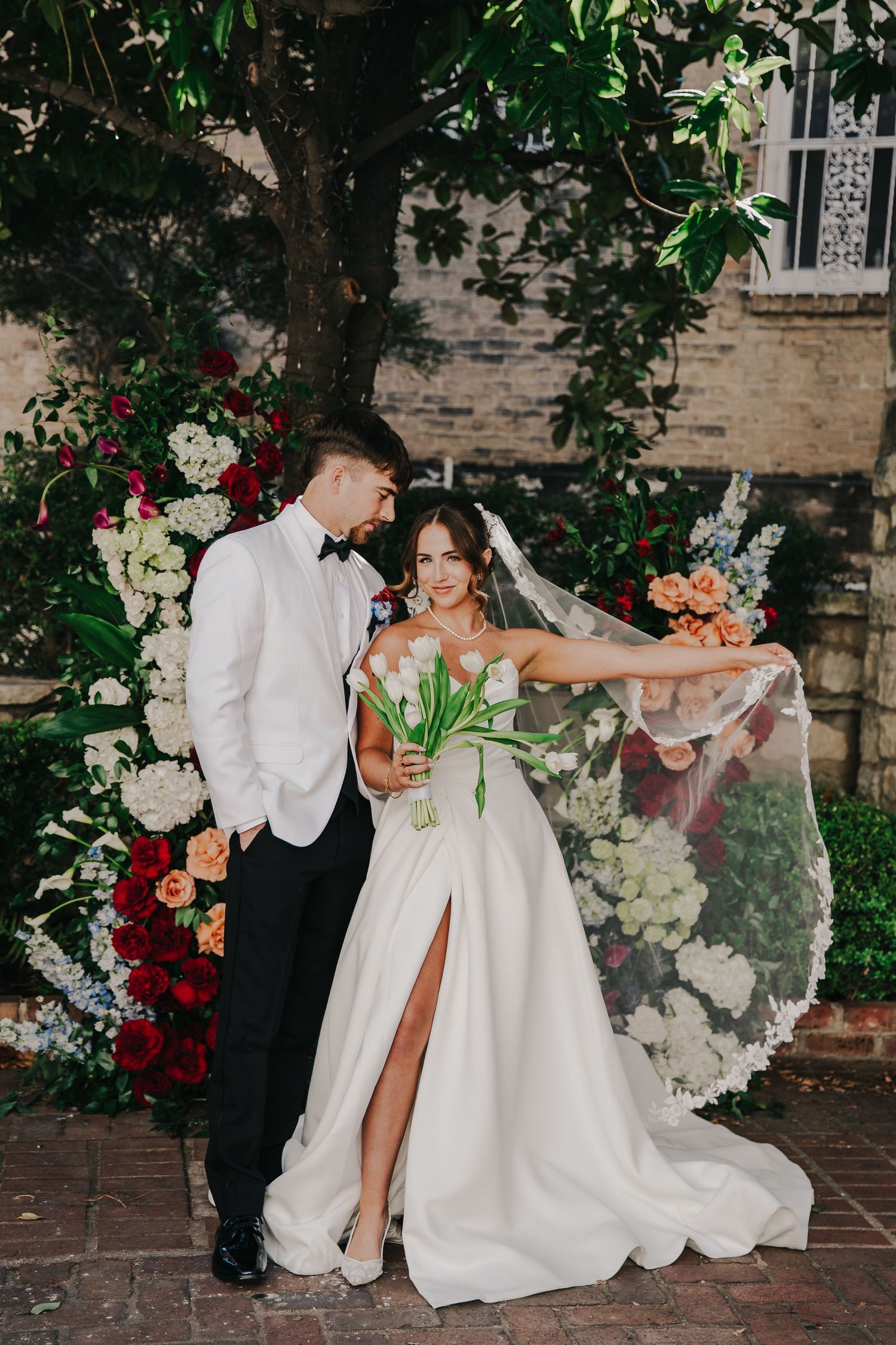 Silhouetted hands reaching toward each other beneath an ornate domed ceiling with classical architectural details.