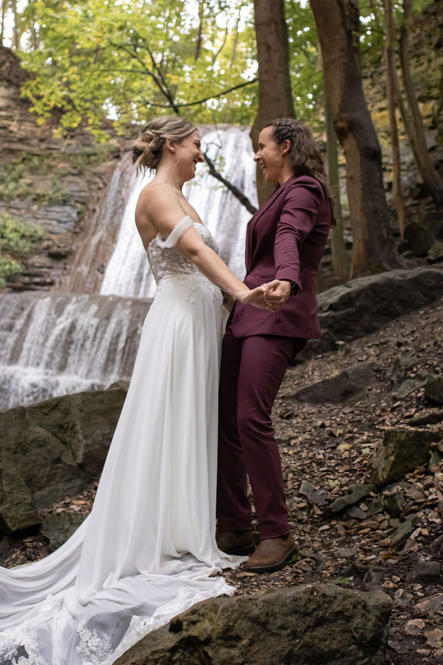 Two brides eloping at Sherman Falls Hamilton with intimate waterfall backdrop