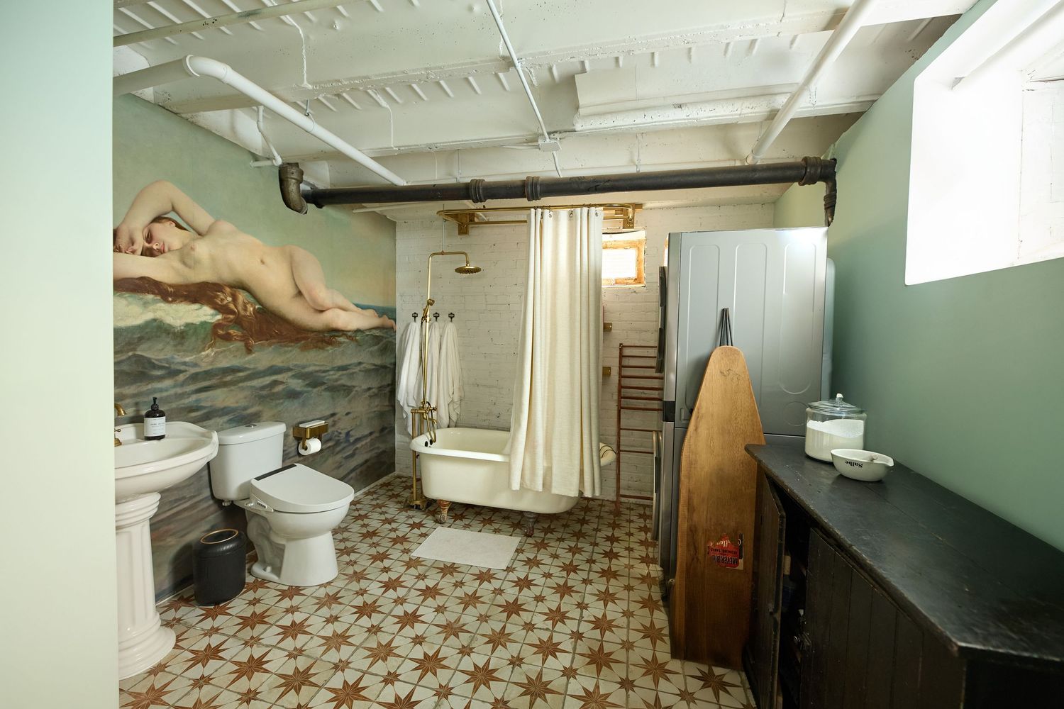 Basement bathroom renovation showing vintage tile floor and new fixtures.