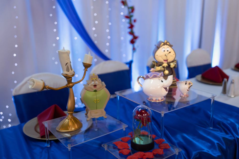 Enchanted rose and Lumiere character Quinceañera dessert table decor. Royal blue and gold themed XV celebration details by Alex T.