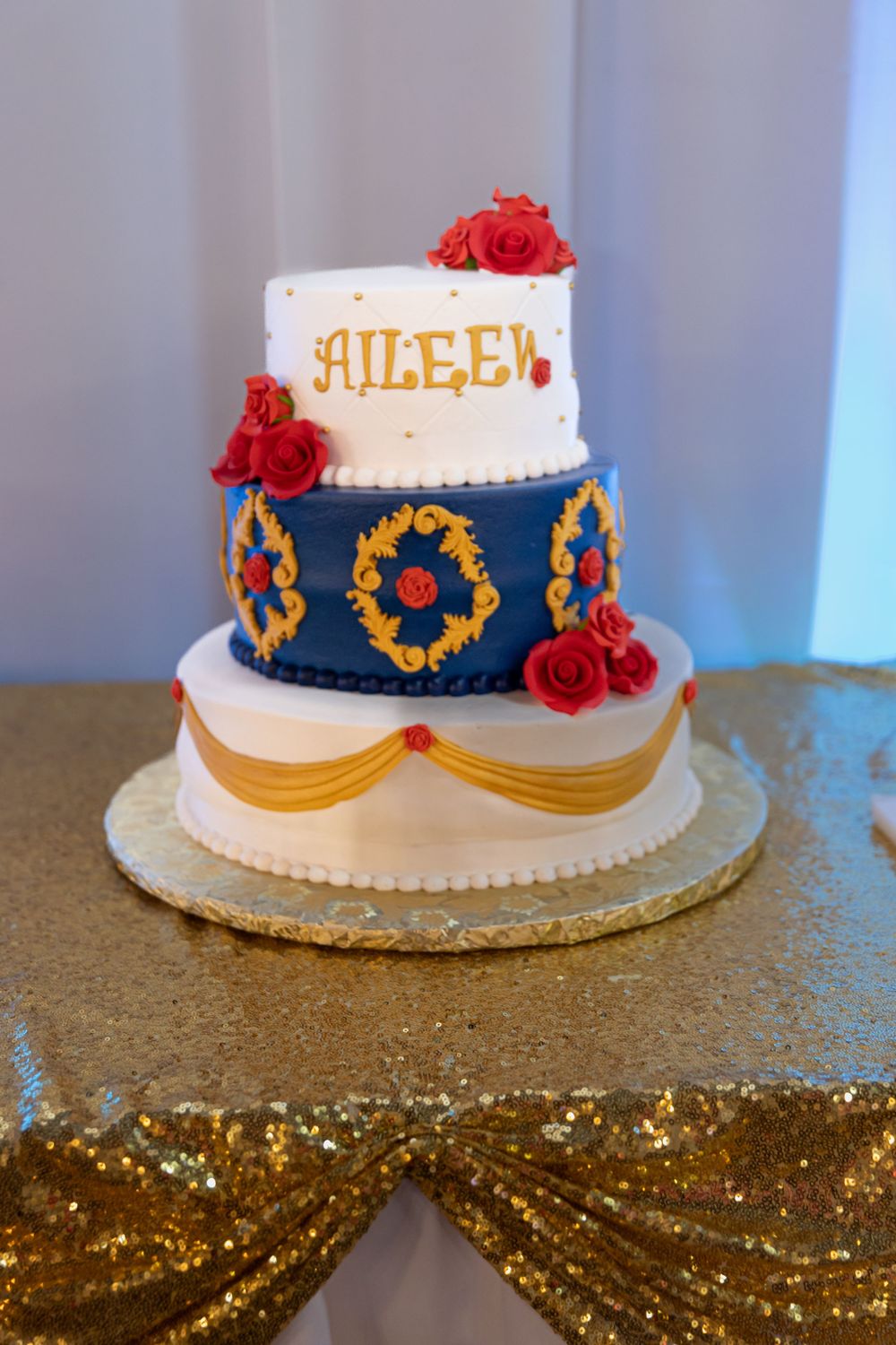 Custom Quinceañera cake with royal blue and gold accents. Beautiful Mis XV dessert table details in Lake County, IL.