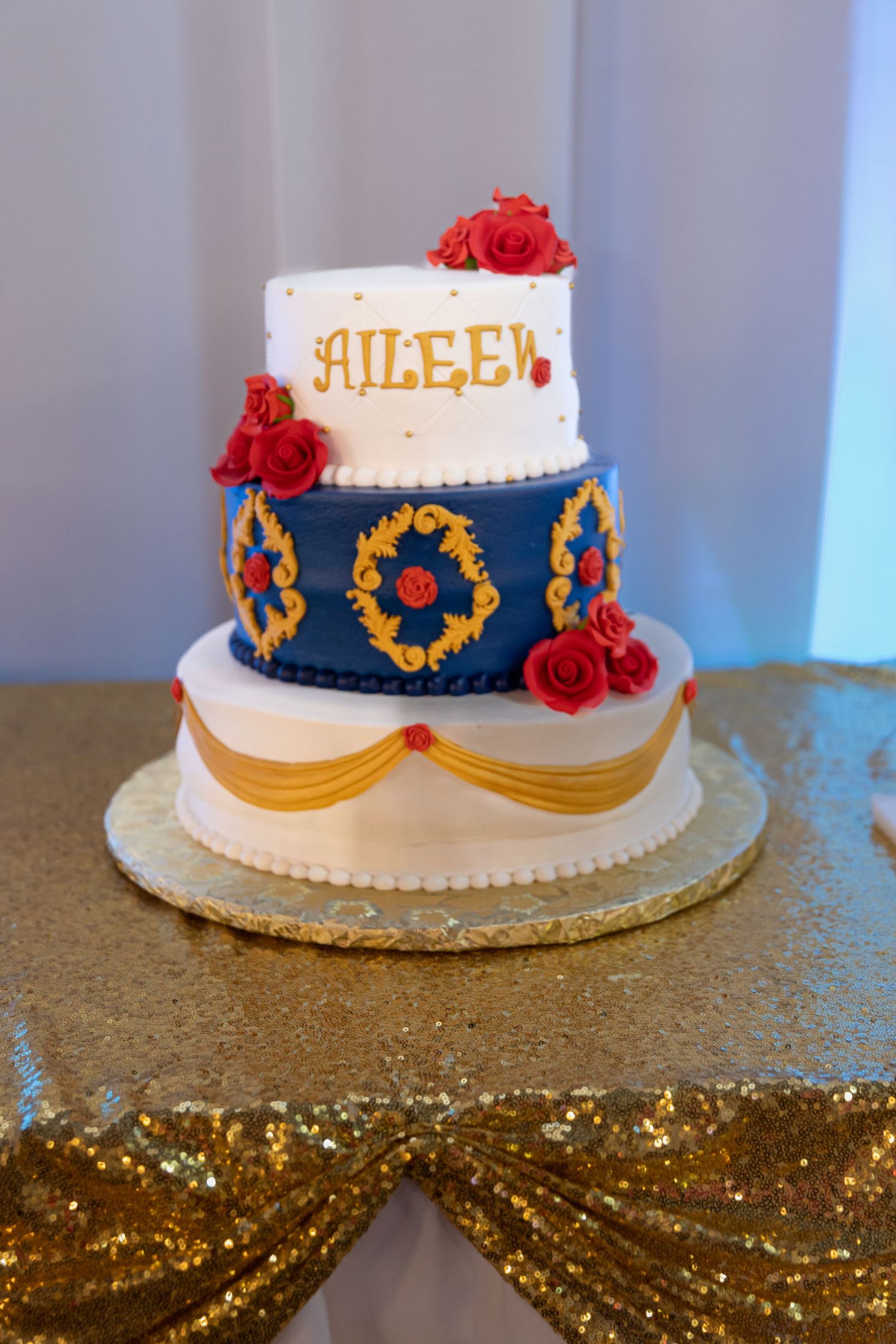 Custom Quinceañera cake with royal blue and gold accents. Beautiful Mis XV dessert table details in Lake County, IL.